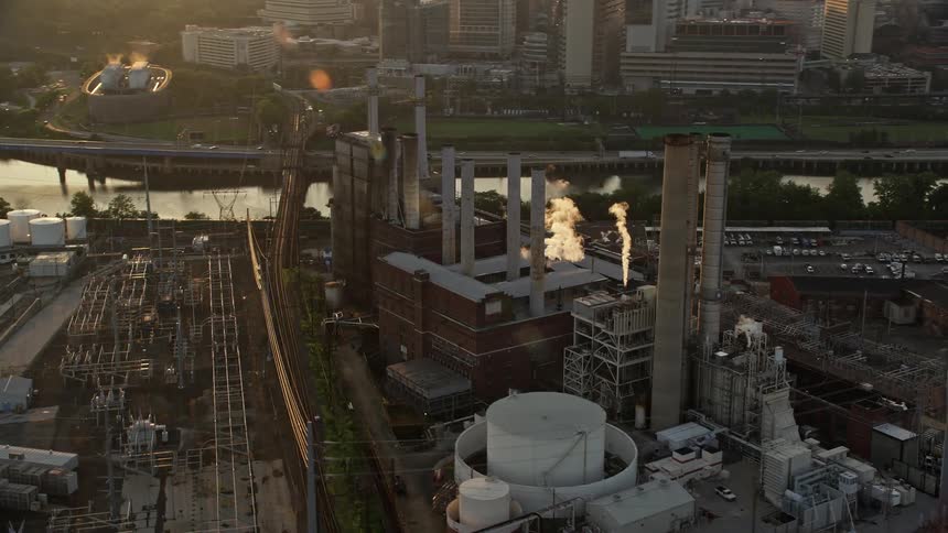 Aerial shot of Veolia Energy power plant in South Philadelphia at sunset with smoke stacks and clear skies