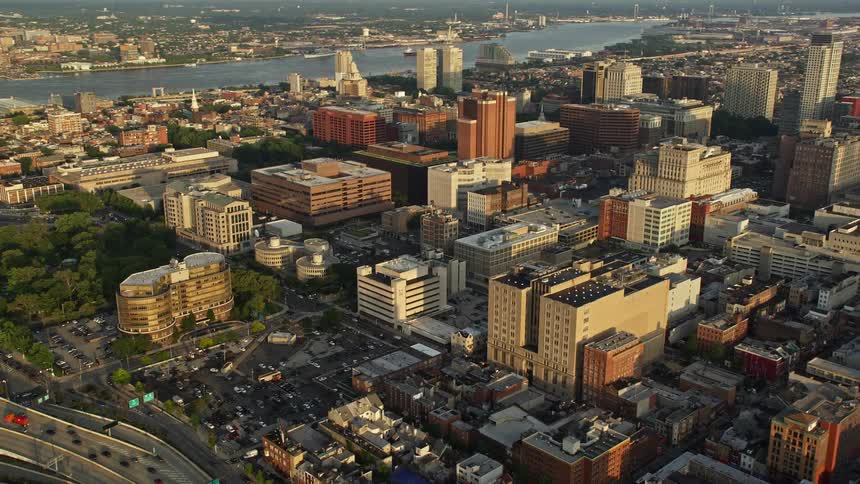 Aerial footage captures the mesmerizing sunset scenery as it soars through the clear skies of downtown Philadelphia revealing its grand building landscape