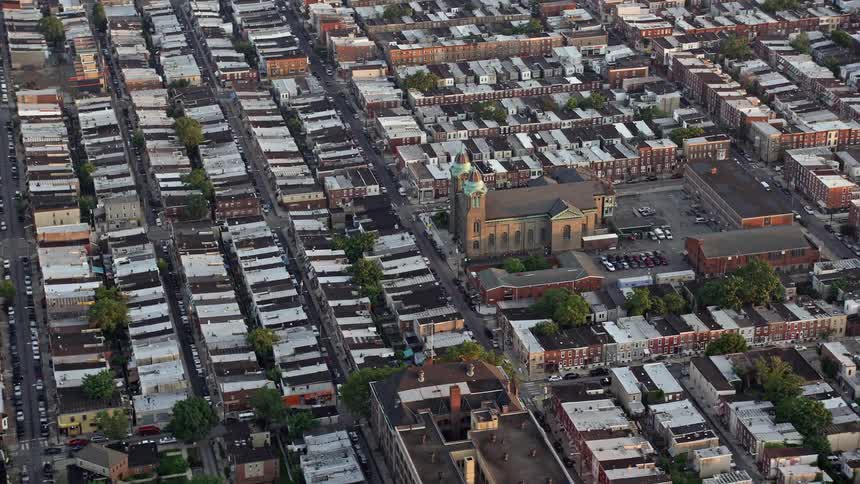 Aerial view of St Thomas Aquinas Catholic Church and row houses during sunset in South Philadelphia