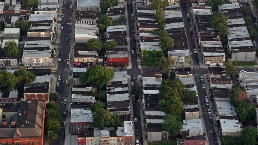 A breathtaking aerial view of row houses and city streets in South Philadelphia Pennsylvania at sunset showcasing the architecture and layout of each home