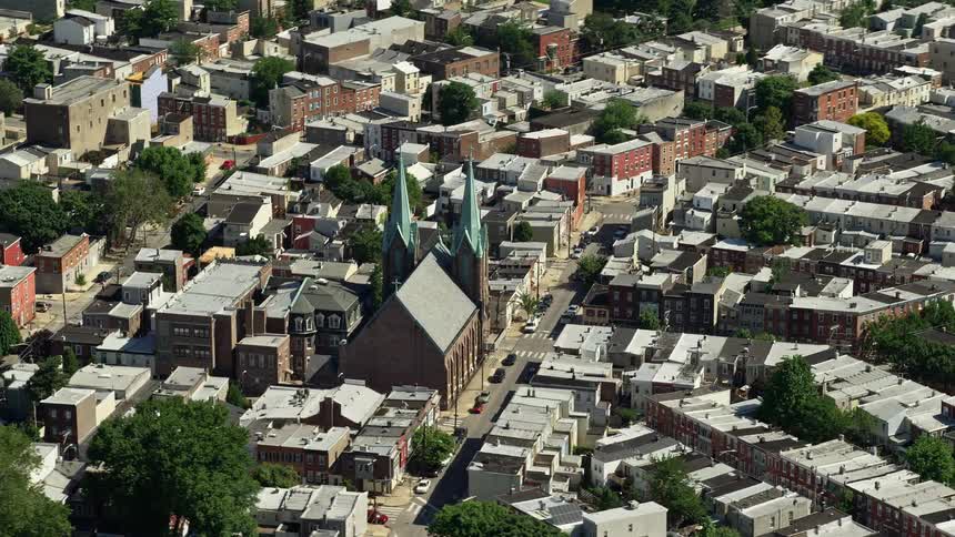 Aerial footage captures the St Laurentius Parish church nestled in a residential urban neighborhood in North Philadelphia