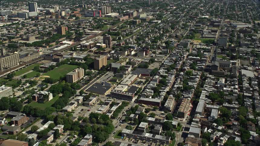 Get a birds eye view of the sunny residential and urban neighborhoods of North Philadelphia in this aerial stock footage