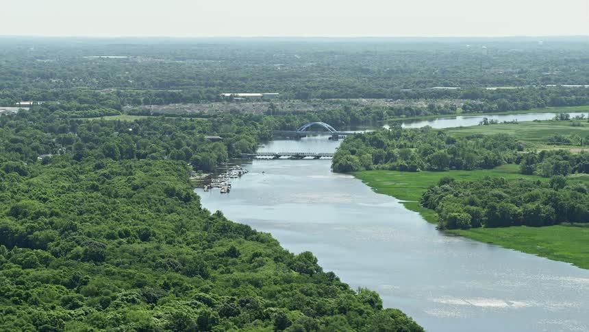 Aerial footage of the Riverside-Delanco Bridge spanning Rancocas Creek in Delanco New Jersey on a hazy day