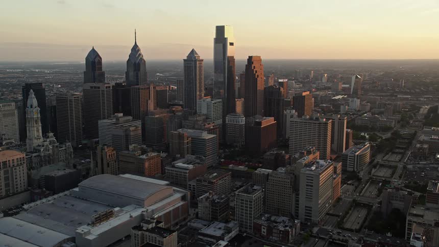 Aerial footage of Downtown Philadelphia skyscrapers and the Pennsylvania Convention Center at sunset