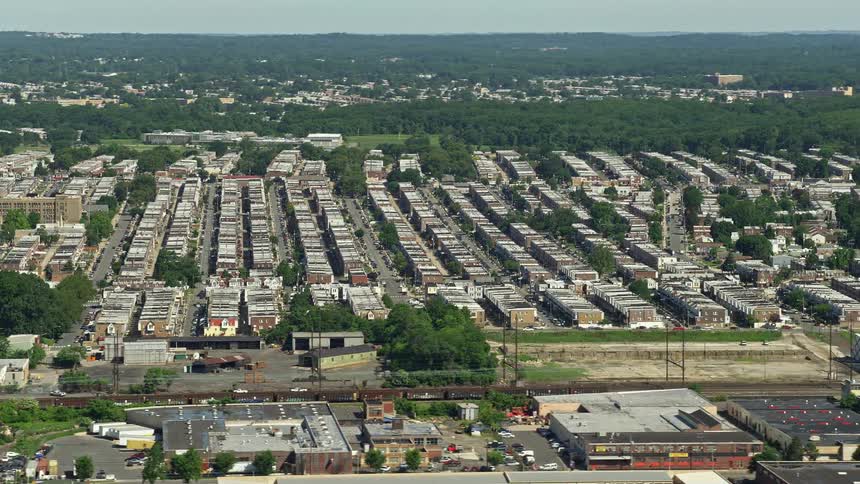 Aerial footage of urban row houses in Philadelphia Pennsylvania on a sunny day