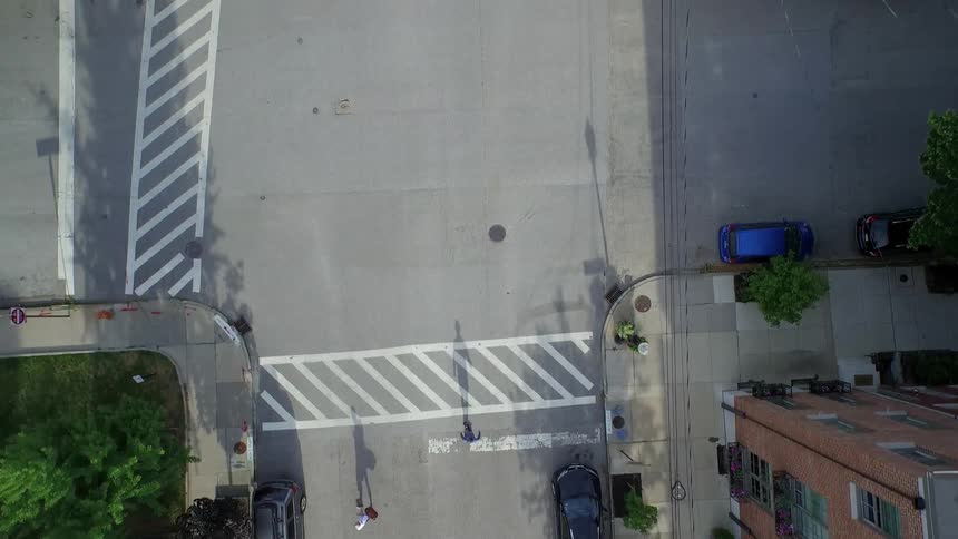 A person is skateboarding down the street below