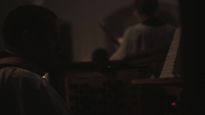 People are singing and playing an instrument in a church