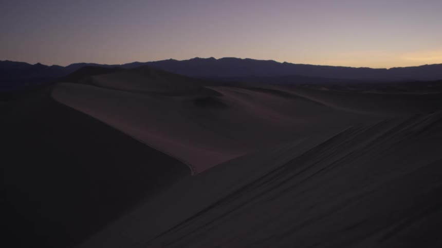 The sun is setting over this desert