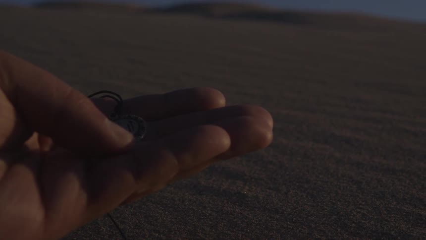 Man holding some coins and rubbing them with his thumb