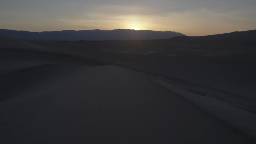 The sun rises over a mountain