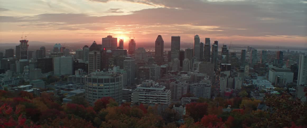The sun rises behind Montreal on an autumn day