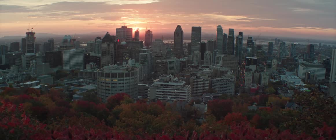 The sun rises behind downtown Montreal in the fall time