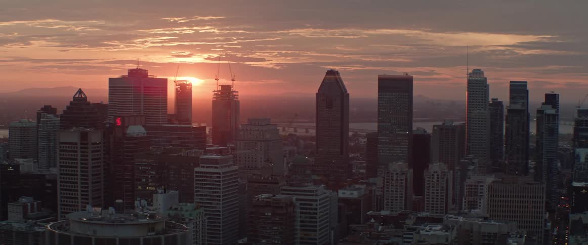 City skyline seen at sunrise on a partly cloudy day