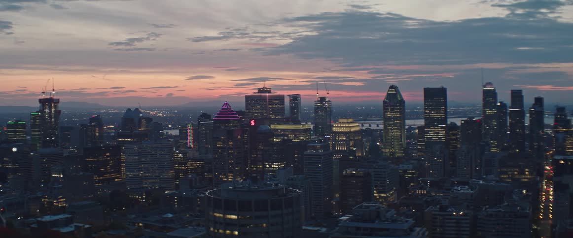 Aerial view of a downtown city during sunrise is displayed