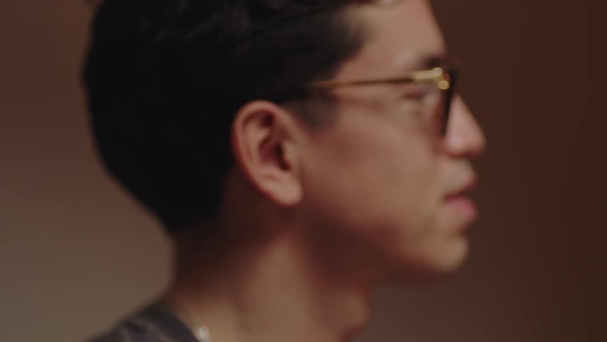 Man wearing eyeglasses listens and nods