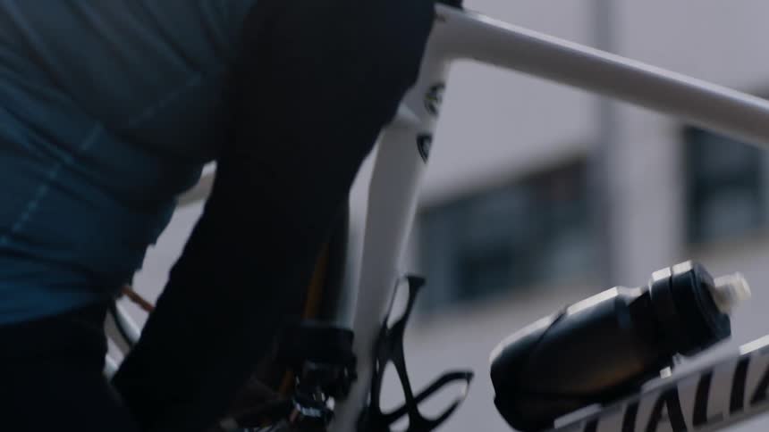 A man is fixing the wheel on his bicycle