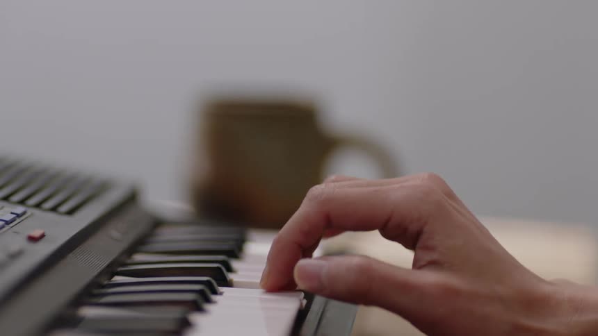 Close up view of a person playing the piano