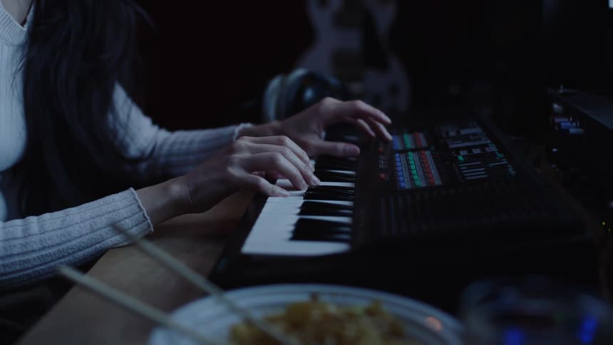 A young woman is playing the instrument indoors