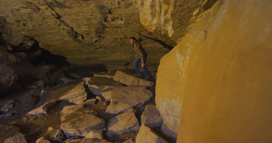 A man is hiking through a rocky terrain outdoors