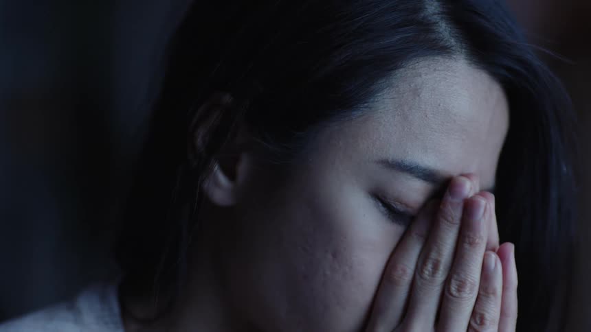 A woman has her hands on her face