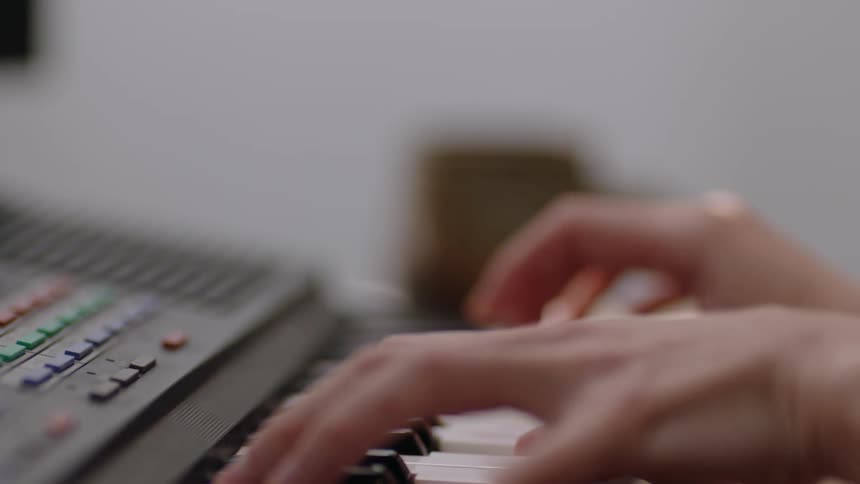 A young person is playing the keyboard inside