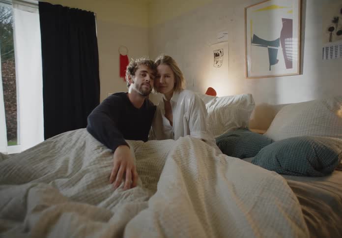 Man and woman are sitting on their bed together
