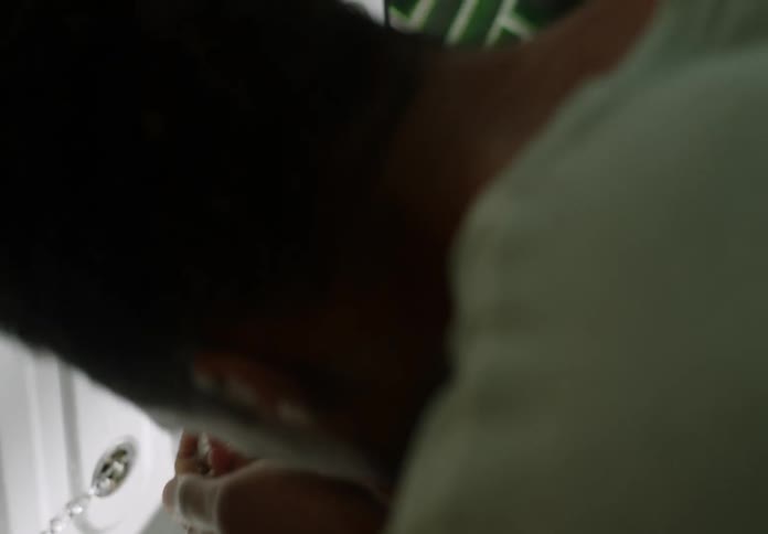 A man is rinsing his face with sink water in bathroom