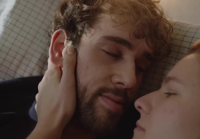 A man and womans faces close up holding each other sentimentally and smiling