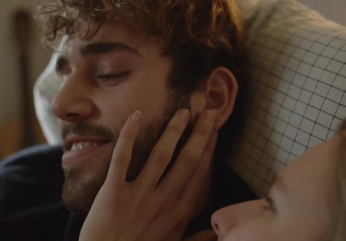 Woman and man are showing affection together indoors