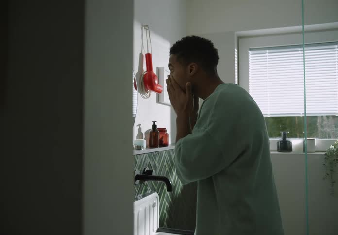 A man is washing his face