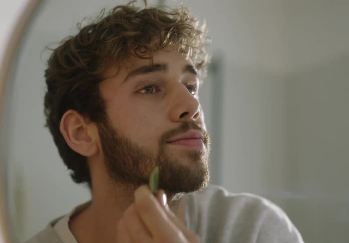 A man is smoothing his skin