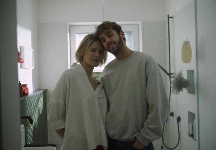 Man and woman are standing near each other in a bathroom