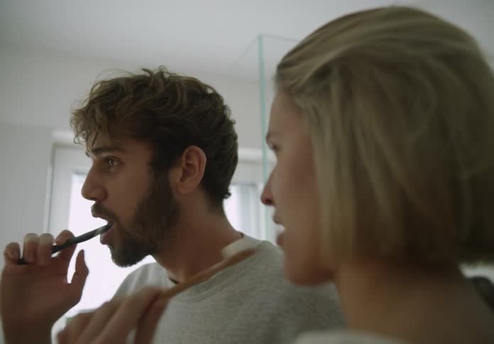 Young couple is brushing there teeth in the bathroom together