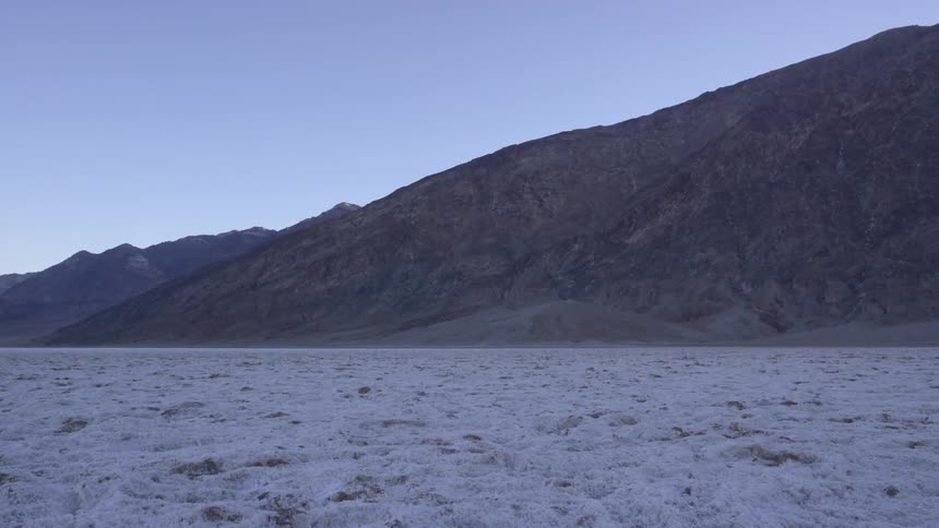 A mountain in a desert on a clear day