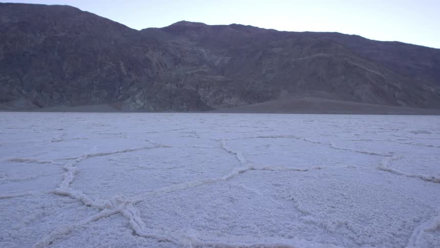 A white field leads to some mountains
