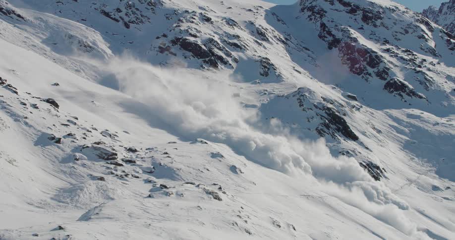 Snow covers the rough terrain of a mountainside during an avalanche