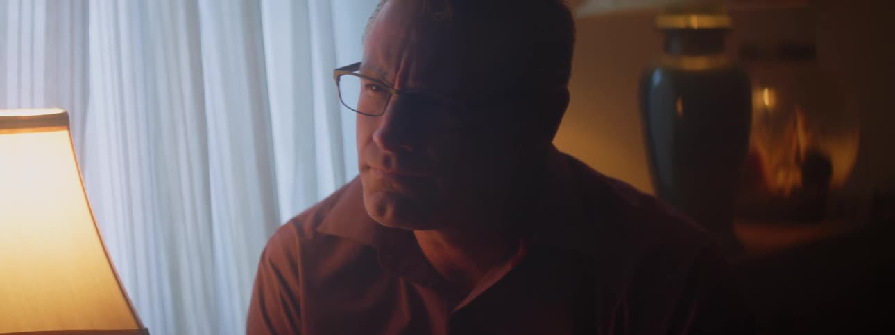A man nods and smiles while listening during a conversation