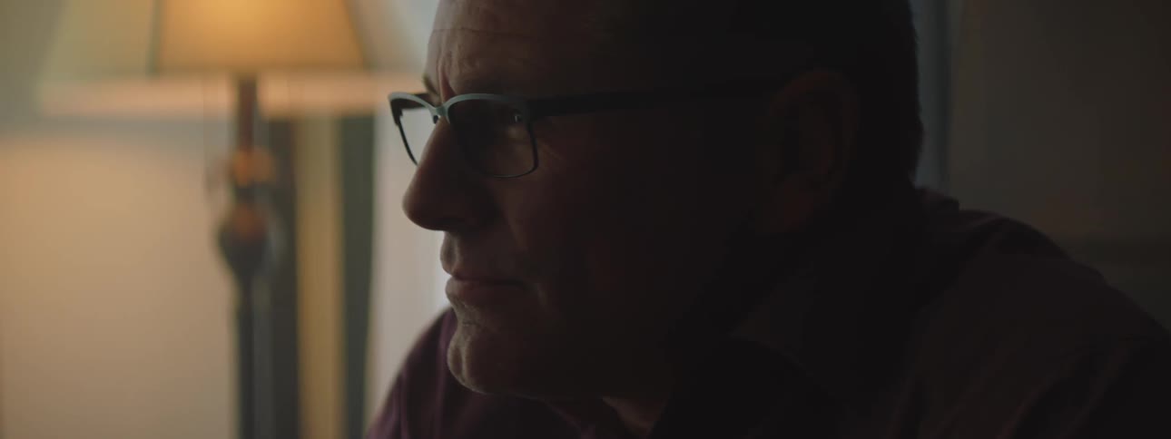 Side profile of man with glasses looking into space