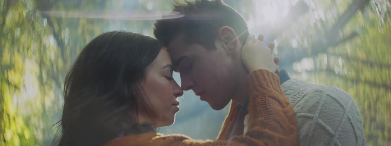 A man and woman are kissing