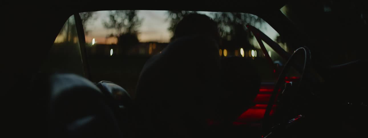A man getting into his car at night