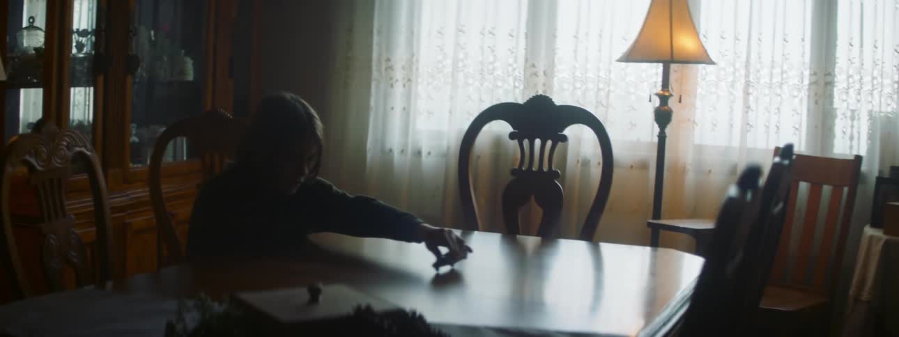 A child plays with a toy car on the table