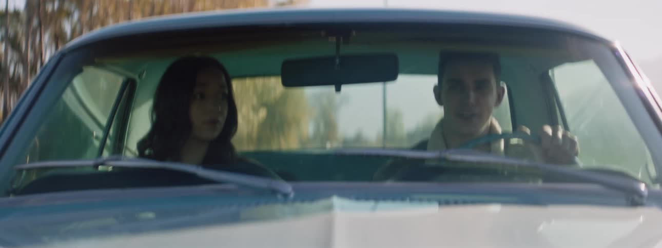 A man and woman are traveling in a car