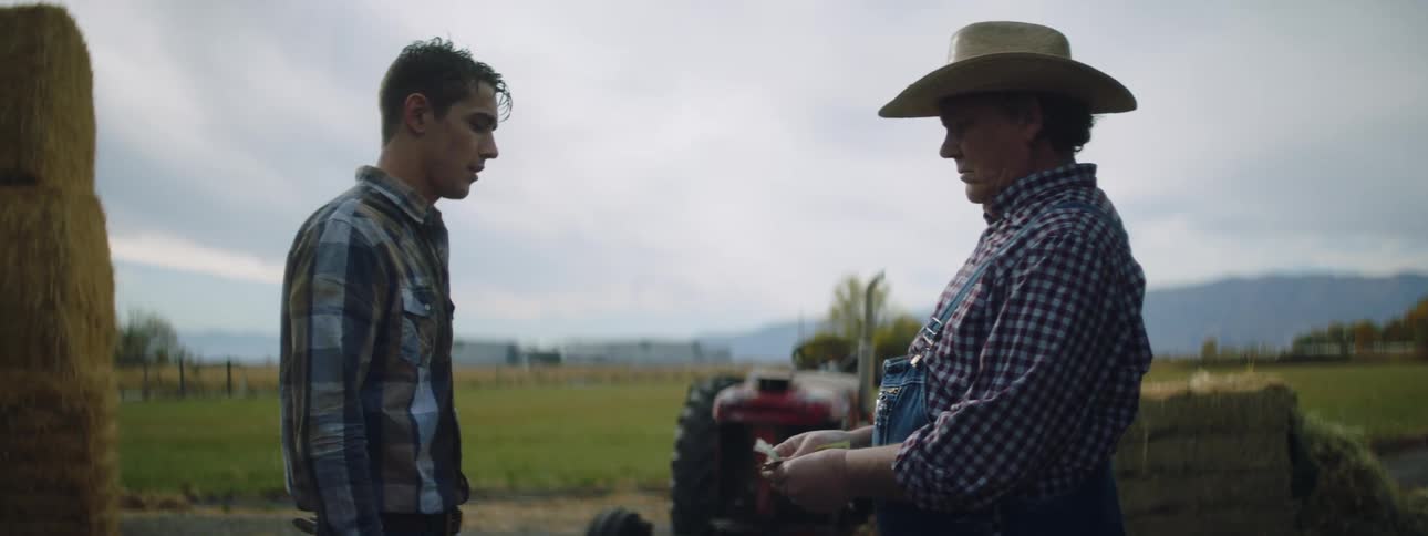 A man handing money to another person