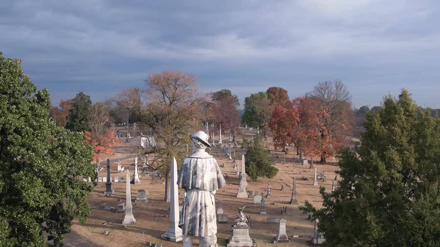 The cemetery has a statue of a person in front