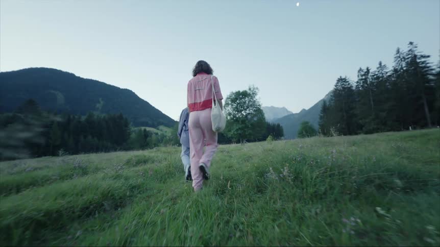 Two women hike together