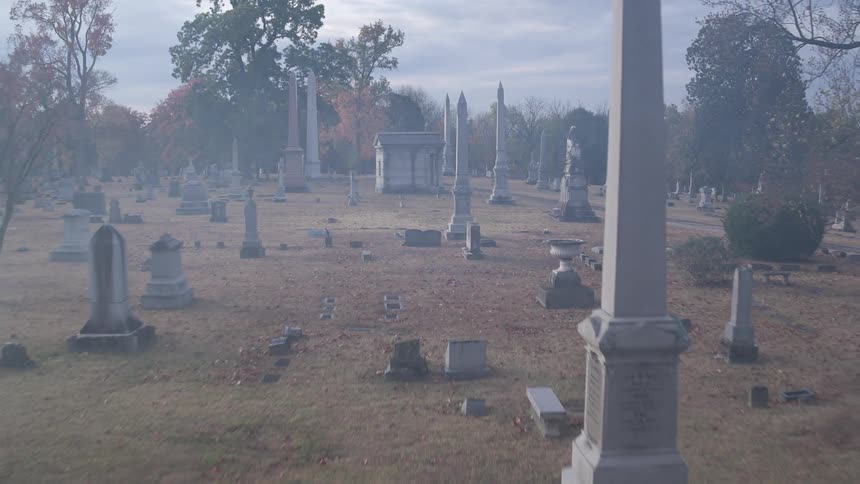 A bleak looking cemetery with dry grass