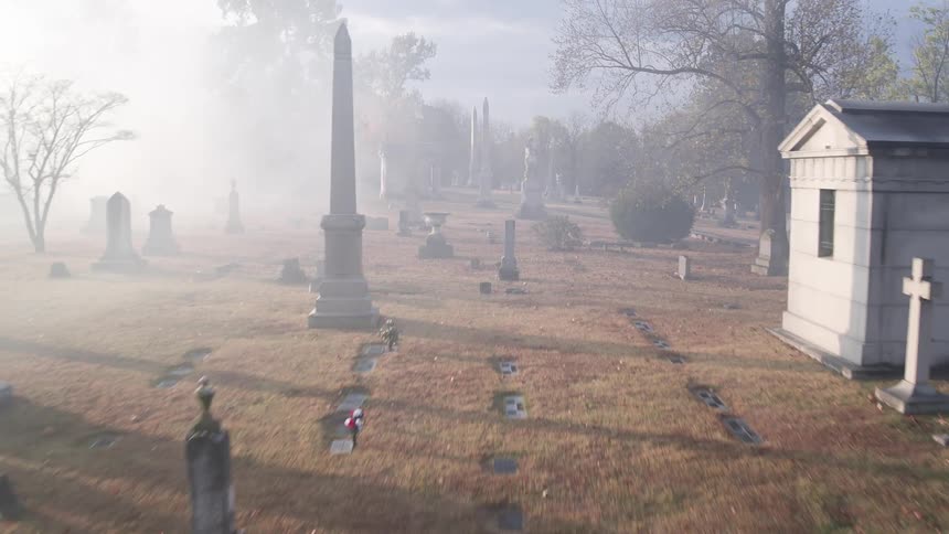 A foggy cemetery during the day