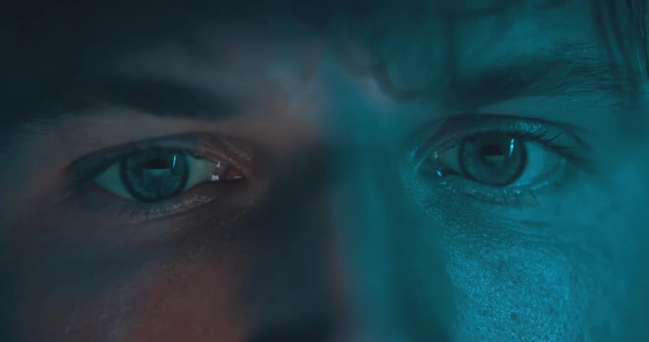 An extreme close up of a mans eyes and face