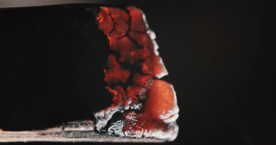 A close up of a hot coal lighting on fire and burning