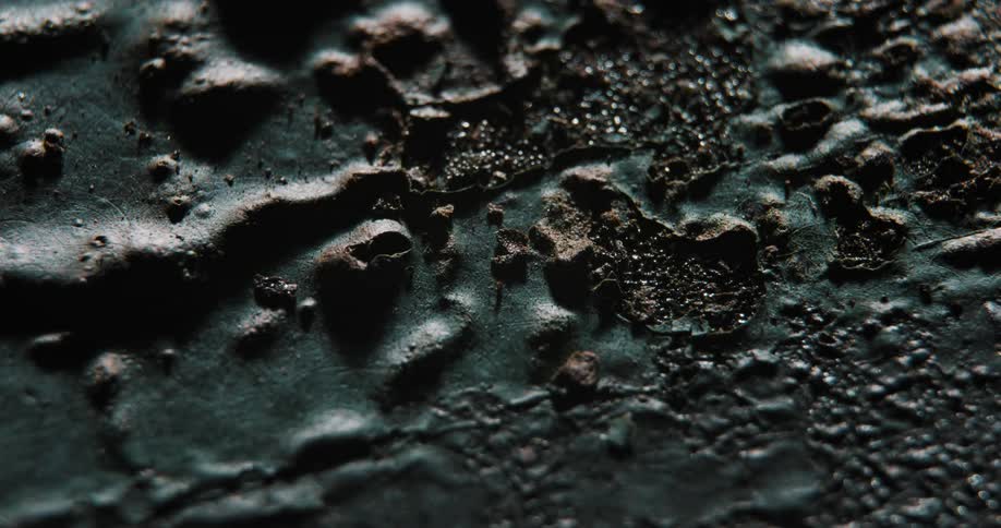 An up close of dark minerals and soil